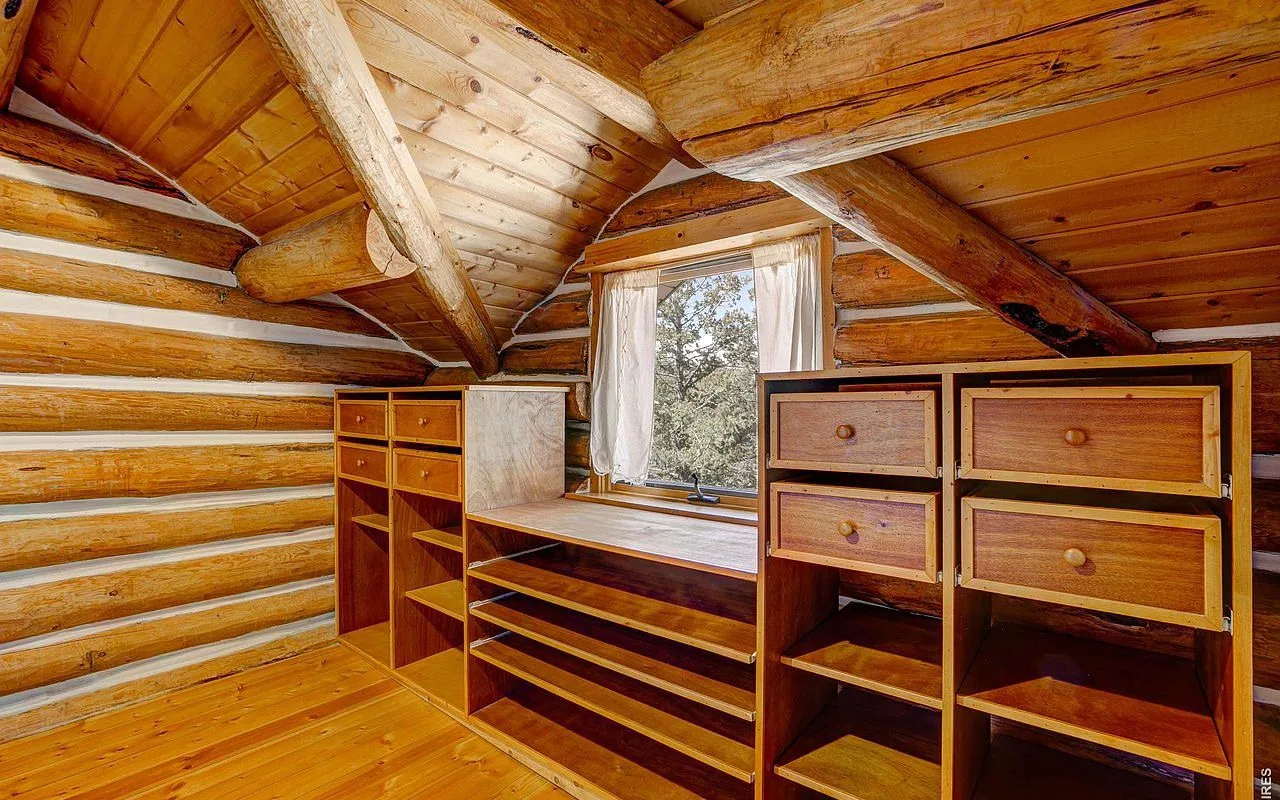 Bedroom built-in storage and dressers tucked under the log lodge eaves