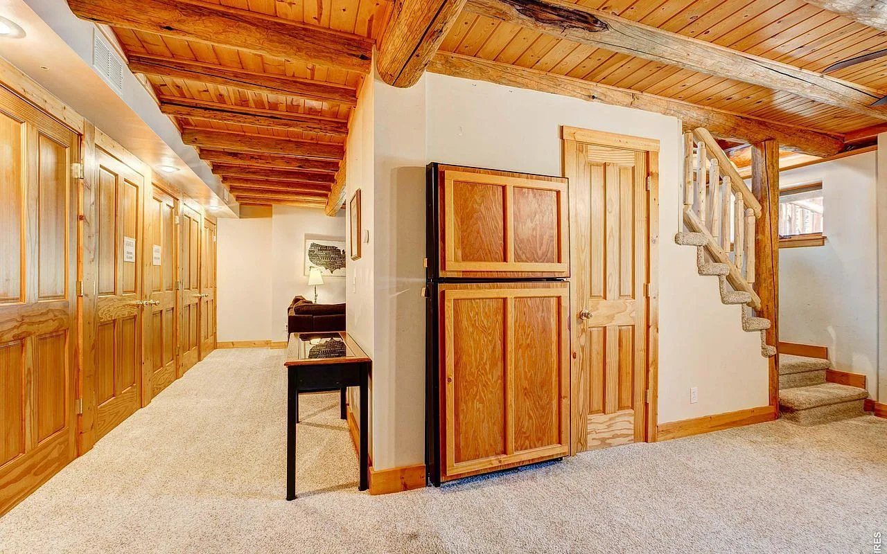 Lower level of the lodge with log staircase, the future Colorado bunk room